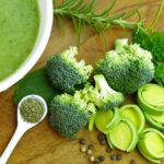 Photo of green vegetables and a bowl of vegetable soup