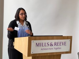 Photo taken at the event showing the chair Parminder Lally speaking at the lectern